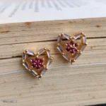 Heart Shaped Red Stone Crystal Earrings with Clear Baguette Stones and Gold-Tone Details - Image 2