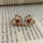 Heart Shaped Red Stone Crystal Earrings with Clear Baguette Stones and Gold-Tone Details